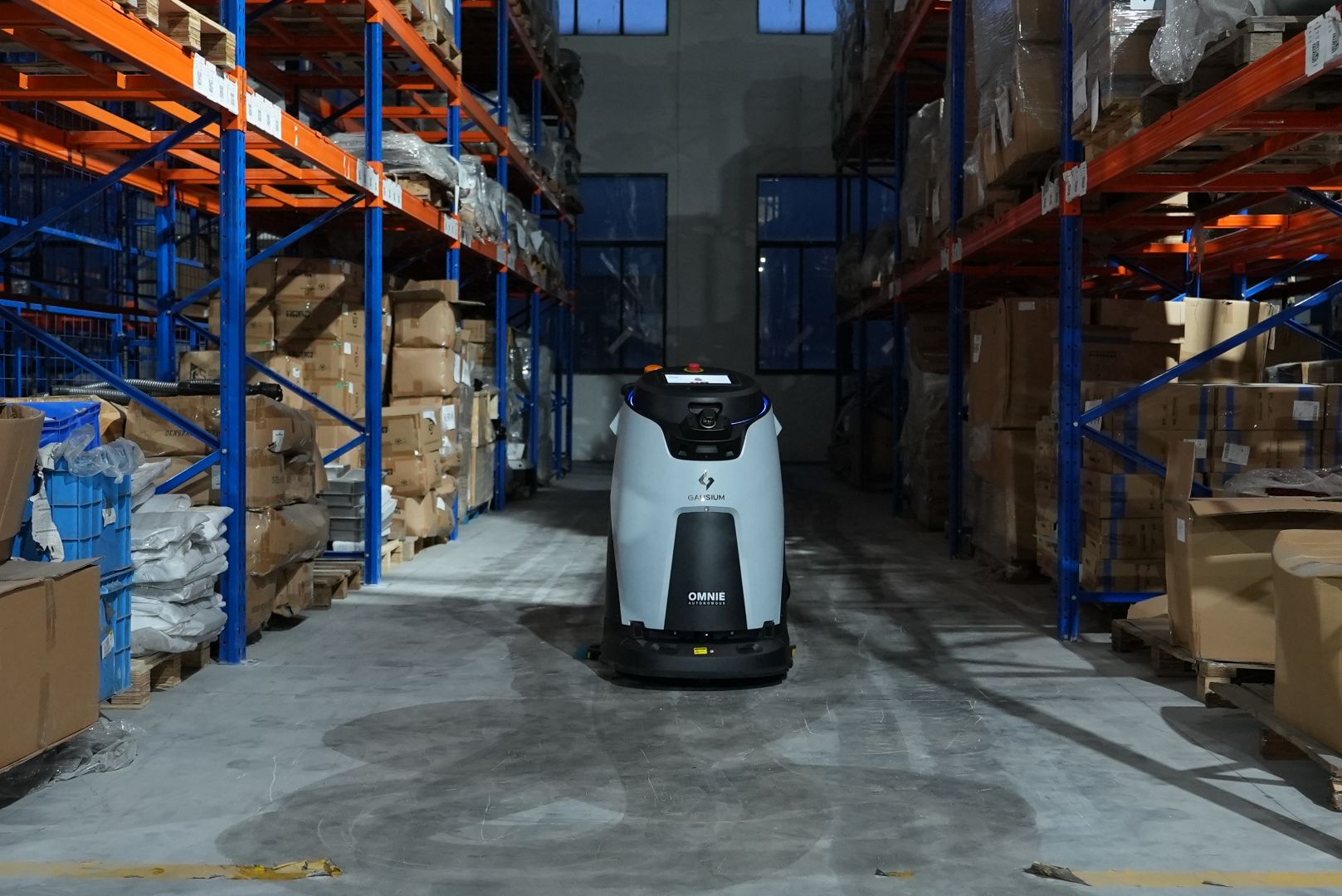 Large warehouse floor cleaned by an industrial robotic floor cleaner usa